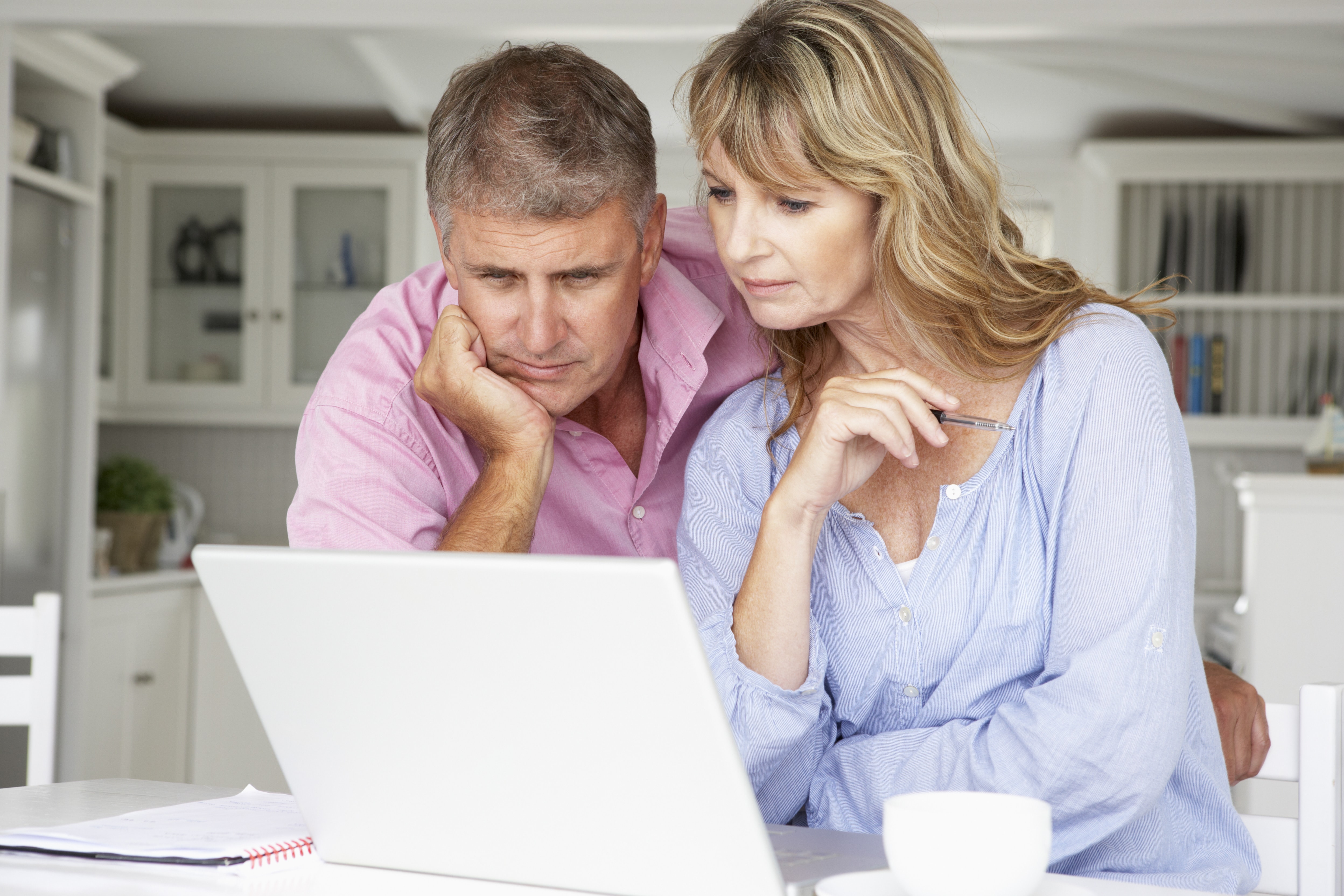 Mid Age Couple Working At Home On Laptop Hammond Law Group